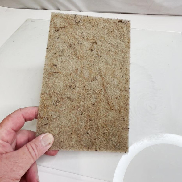 ProTool Coconut Shell Natural Fiber Scrub Pad 6in x 9in, a coarse, rectangular scrub pad made from coconut shell fibers held together with a natural binding, designed for cleaning and scrubbing surfaces.