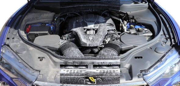 ProTool Power Up Soap 1/2 Gal, car engine with foam cleaning product applied to engine components.