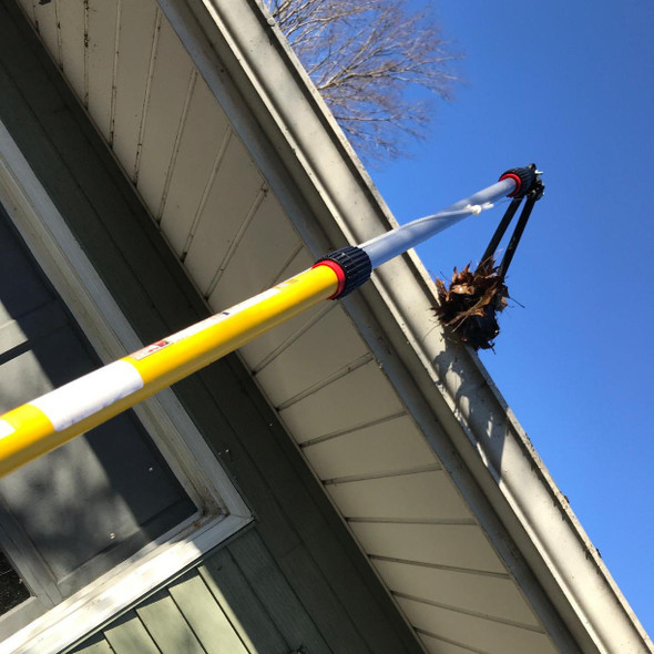 Gutter sense tongs in use for gutter cleaning remove leaves from gutters