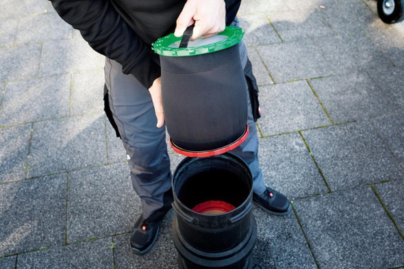 Unger HydroPower Ultra 1-Stage Replacement Resin (3 Pack), person installing water filter resin into a filtration unit outdoors on paved ground.