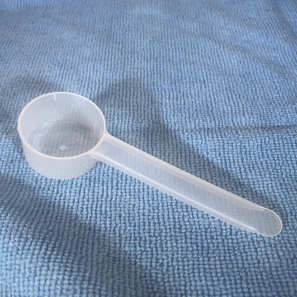 ProTool Scoop for Measuring 1/2oz - 14.8cc, clear plastic measuring scoop with a long handle on a textured blue surface.
