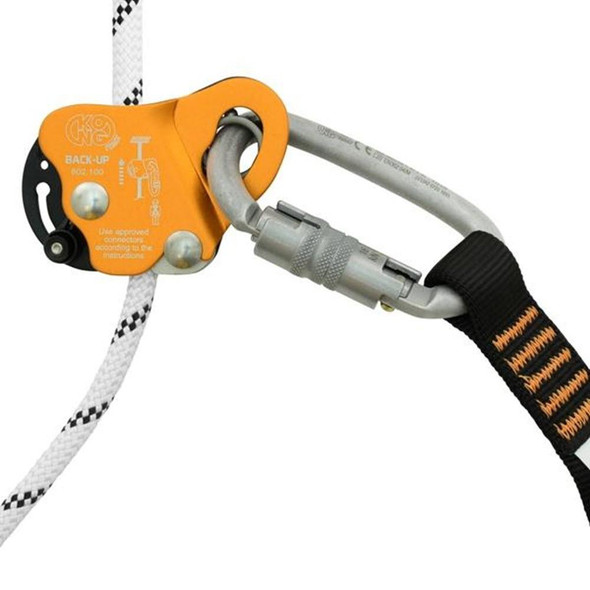 J.Racenstein Rope Grab ANSI 7/16in Back-Up Kong, safety device with an orange and black component, attached to a climbing rope with a metal carabiner and a padded strap.