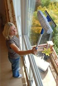 Ettore Complete Window Washing Tool, young girl cleaning a large window with a squeegee and scrubber in a bright room.