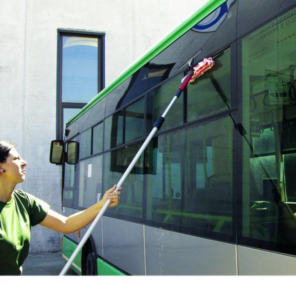 Pulex TechnoDuo Stainless Steel, a professional window cleaning tool with a long extendable pole and microfiber attachment, being used to clean a large glass bus window.
