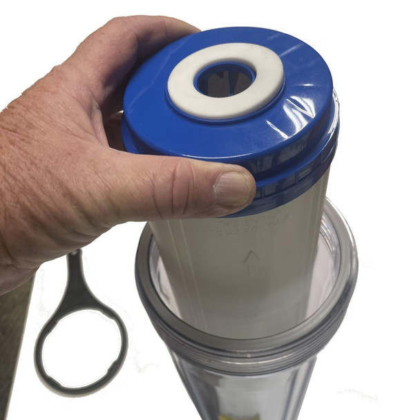 ProTool DI Cartridge Empty 4.5in x 20in, image of a used water filter cartridge with a person's hand holding it, showing the blue end cap and white filter housing.