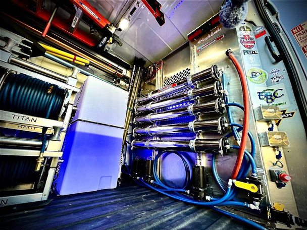 ProTool Dual RO - DI Wall Mount - NANDOLORIAN, industrial water purification system with multiple stainless steel filters, blue and red hoses, and electronic components mounted on metal panels.