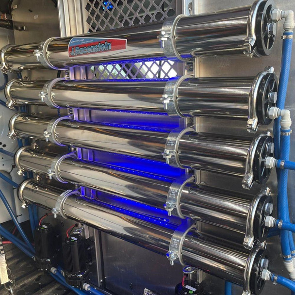 ProTool Dual RO - DI Wall Mount, stainless steel water filtration system with multiple horizontal cylinders for reverse osmosis and deionization process, mounted on a wall with blue and white tubing connections.