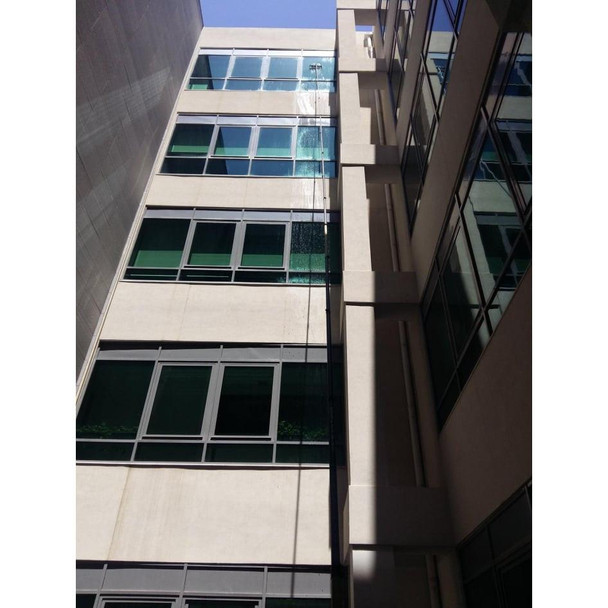 Gardiner Pole Systems Gardiner Ultimate 79ft Tele Pole HM Carbon Kevlar, tall building exterior with glass windows and shadow patterns.