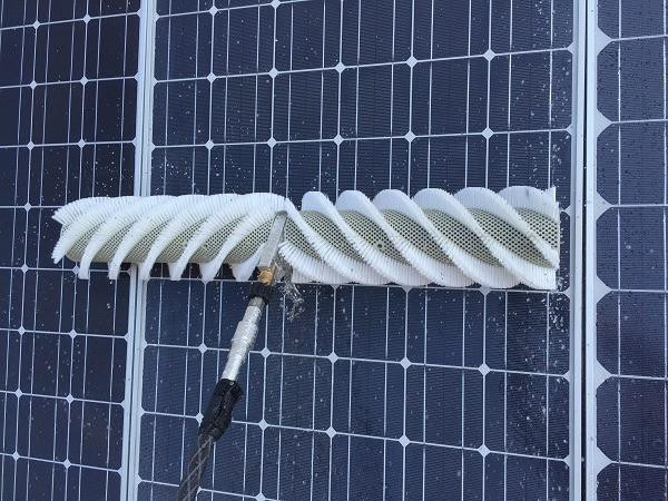 J.Racenstein Gardiner Washing Adaptor 1/4in NPTF x 1/4in NPTF, cleaning solar panel surface with a brush attached to a pole.