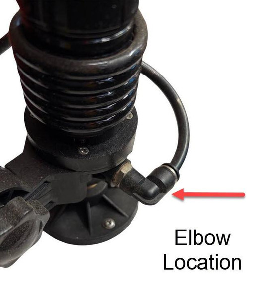 J.Racenstein Elbow Water Hose to Motor Thread, close-up image showing the elbow connector attached to a water hose on a mechanical device with an arrow indicating the elbow location.