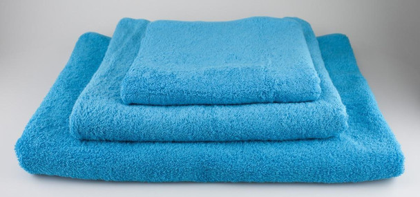 J.Racenstein Terry Towels, set of three plush blue terry cloth towels folded for display.