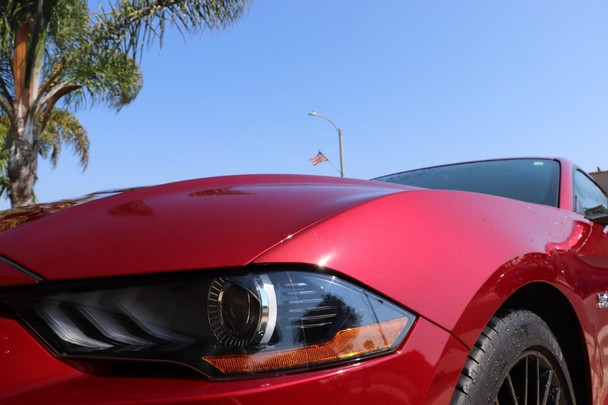 ProTool Shine Up Soap 1/2 gal, image of a red sports car being cleaned with the soap, showcasing the car's shiny, polished surface.