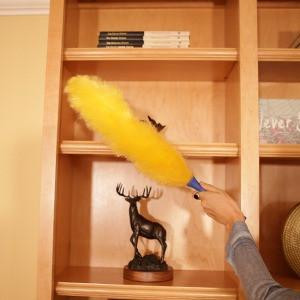 Ettore Duster Static Ettore, handheld yellow duster cleaning wooden bookshelf with a blue handle