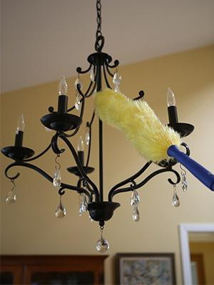 Ettore Duster Static Ettore, dusting chandelier with a yellow duster on a blue handle.