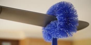 Ettore Ceiling Fan Duster, close-up of blue duster being used to clean a ceiling fan blade.