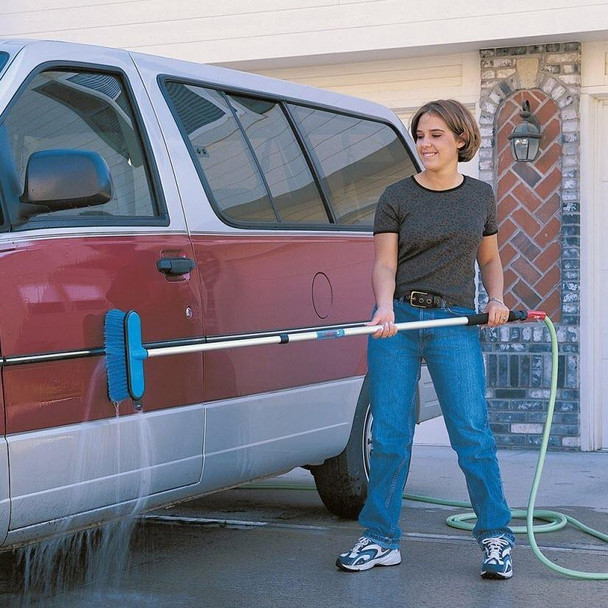 J.Racenstein Brush 10in Blue Soft HydraSoar FlowThru, woman cleaning car with brush on driveway.