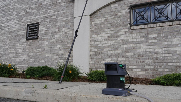 Unger HydroPower Ultra 1-Stage, commercial window cleaning equipment with water-fed pole system and filtration unit outside a building.