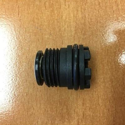 ProTool Burp Button Assembly, black cylindrical component with multiple ridges and connectors on a wooden surface.