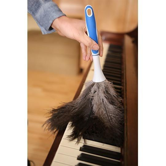 Ettore Ostrich Feather Duster 15 inch, featured being used to clean a piano.