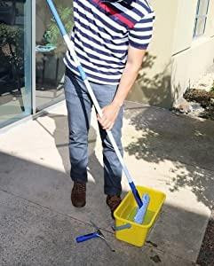 Ettore ProGrip Window Cleaning Kit, person using the squeegee and mop for glass cleaning outside a building.
