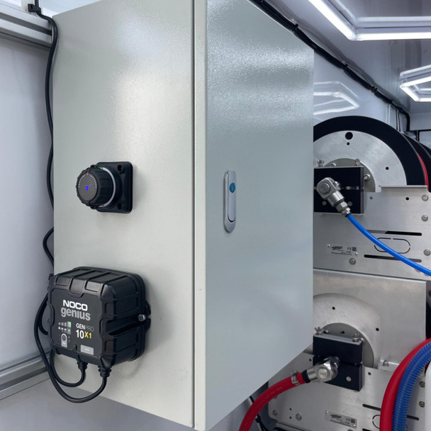 ProTool Enclosed Pressure and Soft Washing Drone Trailer, close-up of the trailer's equipment including a control box, wiring, and coolant system for drone washing operations.