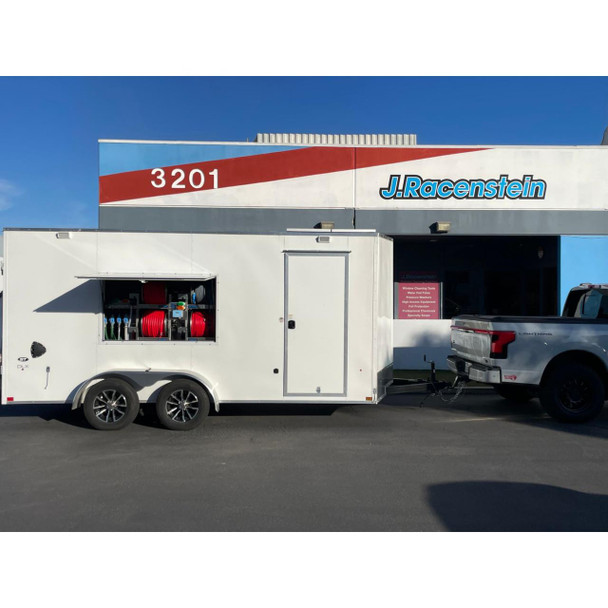 ProTool Enclosed Pressure and Soft Washing Drone Trailer, white enclosed trailer with pressure washers, soft wash equipment, and hoses, parked outside J. Racenstein store.