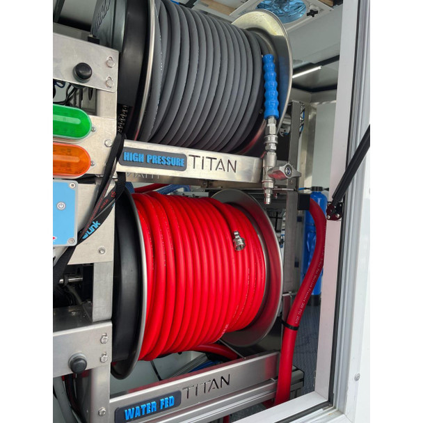 ProTool Enclosed Pressure and Soft Washing Drone Trailer, detailed view of the high-pressure and water-fed hoses coiled on water tanks within an enclosed trailer.