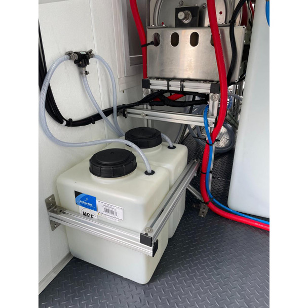 ProTool Enclosed Pressure and Soft Washing Drone Trailer, image showing the equipment setup with white tanks, hoses, and red and black cables inside a trailer.