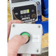 Spring Controller, Reel Rewinder With Remote Button Pendant, close-up of the white control box with a green start button and a white start button.