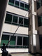 Gardiner Pole Systems Gardiner Ultimate 90ft Tele Pole HM Carbon Kevlar, extending pole reaching high rise building for window cleaning or maintenance.