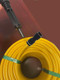 J.Racenstein Gardiner Angle Adaptor QuicK-LoQ Resi-Neck 1Std, yellow coiled tubing with black connector and metal tool.