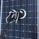 J.Racenstein Gardiner Washing Adaptor 3/8in NPTF x 1/4in NPTF attached to solar panel surface for cleaning or maintenance.