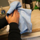 Ettore MicroSwipe Towel 16x20, person using the microfiber towel to clean a surface.