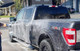 ProTool Foaming Hose End Sprayer, close-up of the sprayer nozzle dispensing foam onto a black pickup truck during cleaning.