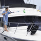 J.Racenstein Pole HydraSoar FloThru 12ft, man cleaning the side of a yacht using a long cleaning pole with a brush attachment.