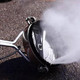 ProTool Surface Cleaner 18in Protool 4000psi, industrial surface cleaning equipment emitting high-pressure water spray onto pavement.