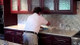 StonePro YouTube Granite Top Restoration Light, a person cleaning a granite kitchen countertop with the StonePro restoration light.