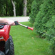 J.Racenstein Spray Gun Long Range Variable Pattern, person using spray gun with a long nozzle to spray a hedge in a garden.