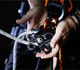 Skylotec Descender SIRIUS for 7/16in or 1/2in Rope, close-up of a person's hands adjusting the mechanical descent device with a rope installed, used for climbing or rappelling safety.
