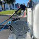 ProTool Auto Detailing Skid, a pressure washer hose reel with spray gun on a mobile cleaning station.