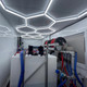 ProTool Enclosed Pressure and Soft Washing Drone Trailer, interior view showing pressure washing equipment with hoses and control units inside a well-lit enclosed trailer.