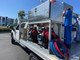 ProTool Drone Pressure Washing Flatbed Skid, equipped with high-pressure pumps, large blue water tanks, and hoses for professional cleaning services.