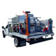 ProTool Drone Pressure Washing Flatbed Skid, industrial equipment for drone-based pressure washing mounted on a truck bed with hoses, tanks, and a crane for tools.