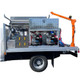 ProTool Drone Flatbed Skid - V-SPEC, truck-mounted aluminum flatbed skid with dual equipment units, diamond-plate storage compartments, and an orange crane.
