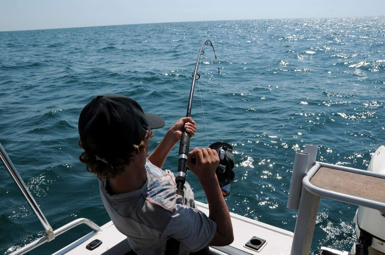 A fisherman reeling in a catch