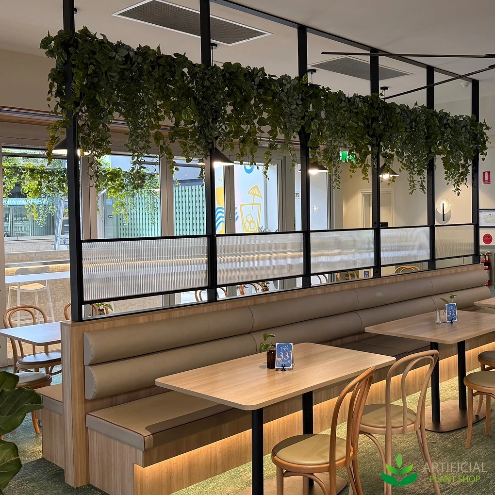 faux trailing plants hung above dining banquettes