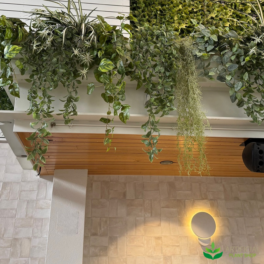 artificial hanging greenery kit above a stone archway in a restaurant