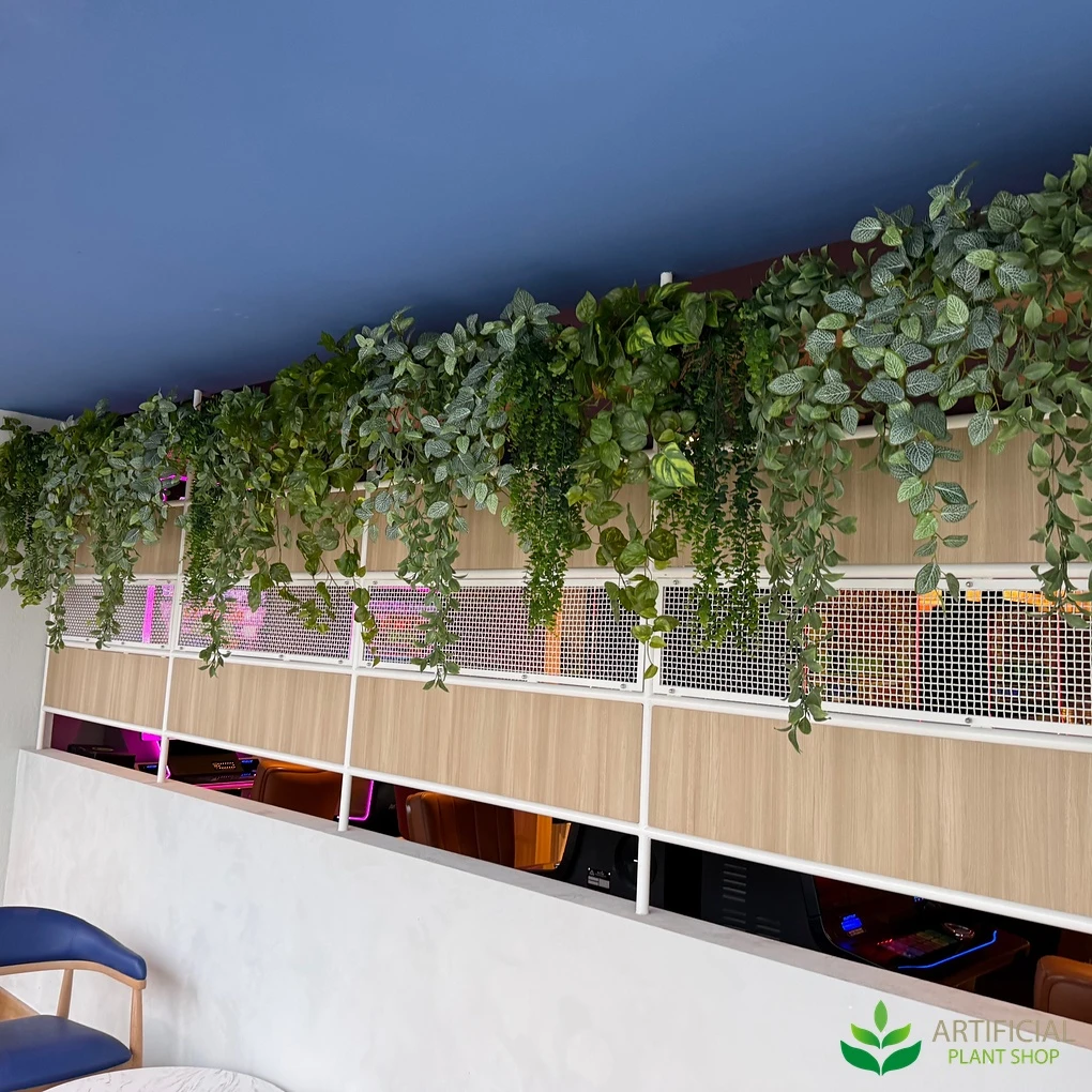 fake hanging greenery along a bar bulkhead with feature lighting