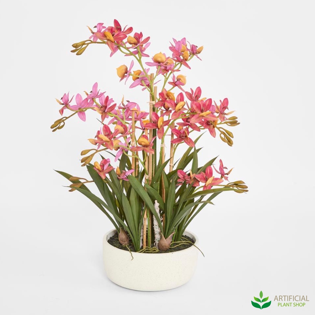 artificial pink orchids in cream pot