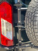 Close-up of the Aluminess carrier mount and folding step on a Transit
